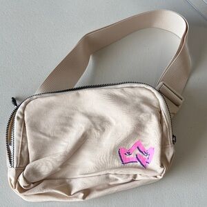Beige Crossbody Sling Bag with Pink Crown Accent